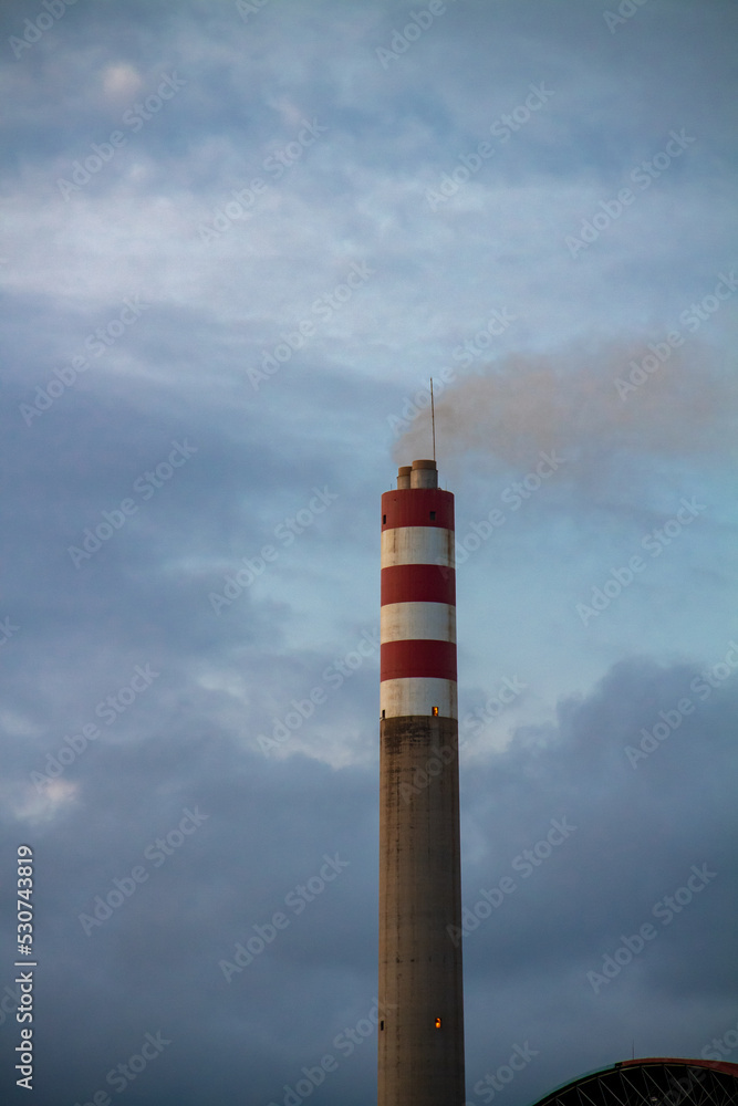 Power plant chimney on blue cloud background Power plant chimney on blue cloud background