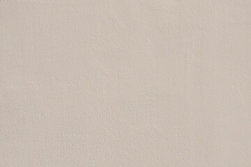 Saturated pastel gray beige colored low contrast Concrete textured background. Empty colourful wall texture with copy space for text overlay and mockups. 2023, 2024 color trend