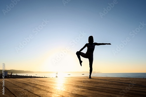 Fototapeta Naklejka Na Ścianę i Meble -  Healthy Yoga woman lifestyle balanced practicing meditate and energy yoga on the bridge in morning and sunset outdoors nature. Healthy life Concept . High quality photo