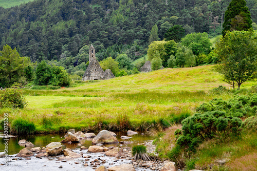 Idyllic view in Glendalough Valley, County Wicklow, Ireland. Mountains, lake and tourists walking paths