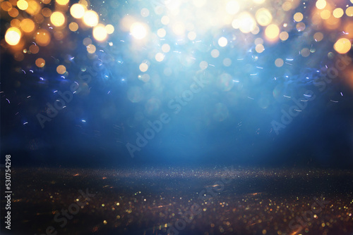 background of abstract glitter lights. gold, blue and black. de focused photo