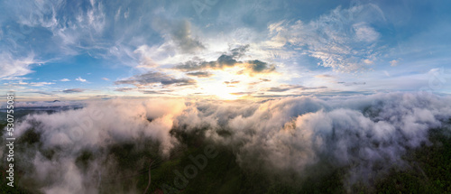 Aerial view Beautiful panorama of morning scenery Golden light sunrise And the mist flows on high mountains forest. Pang Puai, Mae Moh, Lampang, Thailand.