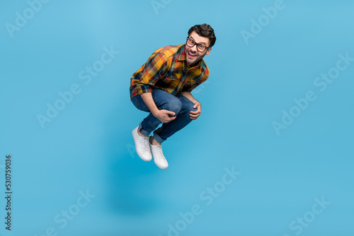 Wallpaper Mural Full body photo of overjoyed glad person jumping falling toothy smile isolated on blue color background Torontodigital.ca