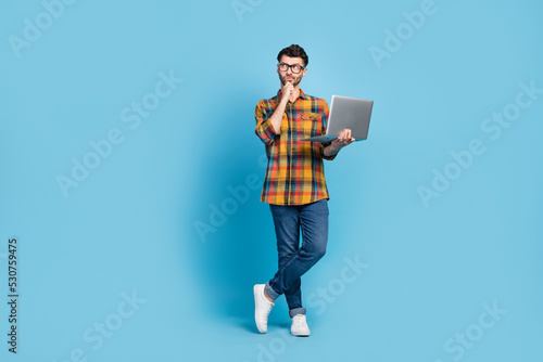 Obraz na plátně Full length portrait of minded person hold netbook hand touch chin look empty sp