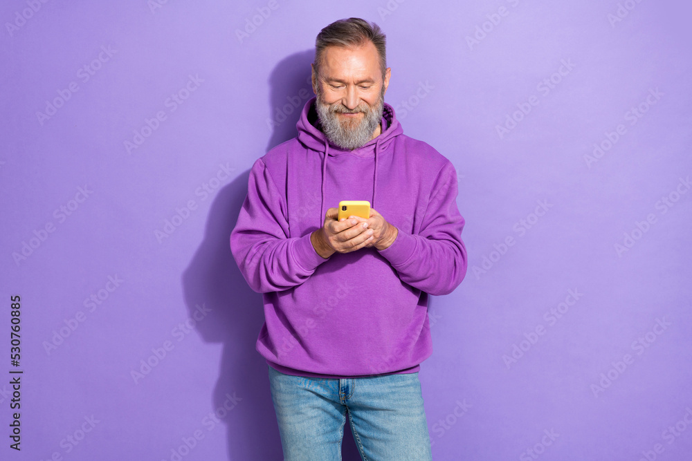 Portrait photo of old aged handsome pensioner phone facebook new account user isolated on pastel purple color background Portrait photo of old aged handsome pensioner phone facebook new account user isolated on pastel purple color background