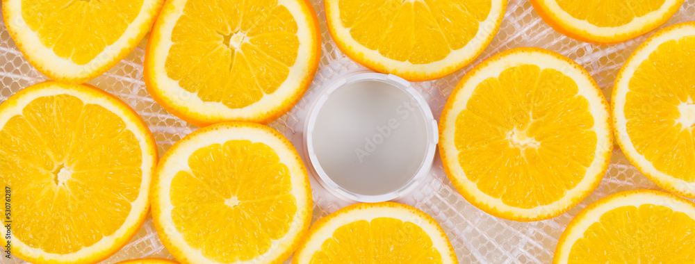 on a white round grate, sliced orange fruit,..for further drying, close-up on a white round grate, sliced orange fruit,..for further drying, close-up