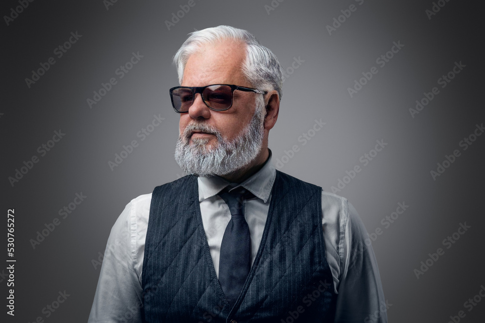 Portrait of cool old man with sunglasses dressed in waistcoat and white shirt. Portrait of cool old man with sunglasses dressed in waistcoat and white shirt.