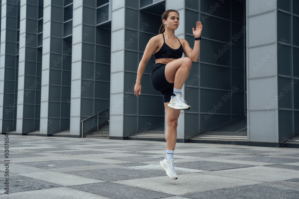 Shot of female athlete warming up preparing to running in city. Shot of female athlete warming up preparing to running in city.