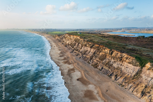 Aerial view of people taking a walk along Hengistbury Head beach, Southbourne, Dorset, United Kingdom. photo