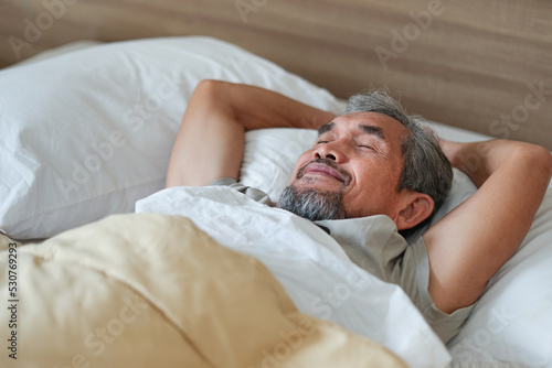 happy senior man asleep on the bed,older adult asian man sleeping comfortably in blanket. concept elderly people lifestyle, get enough rest,health care