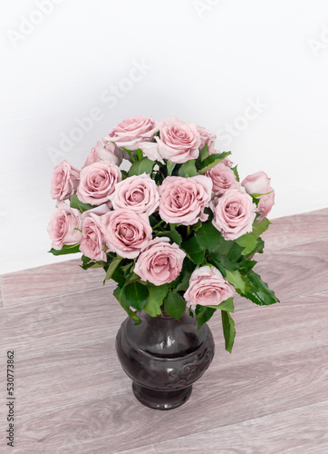 bouquet of beautiful pink roses with water drops in a vase