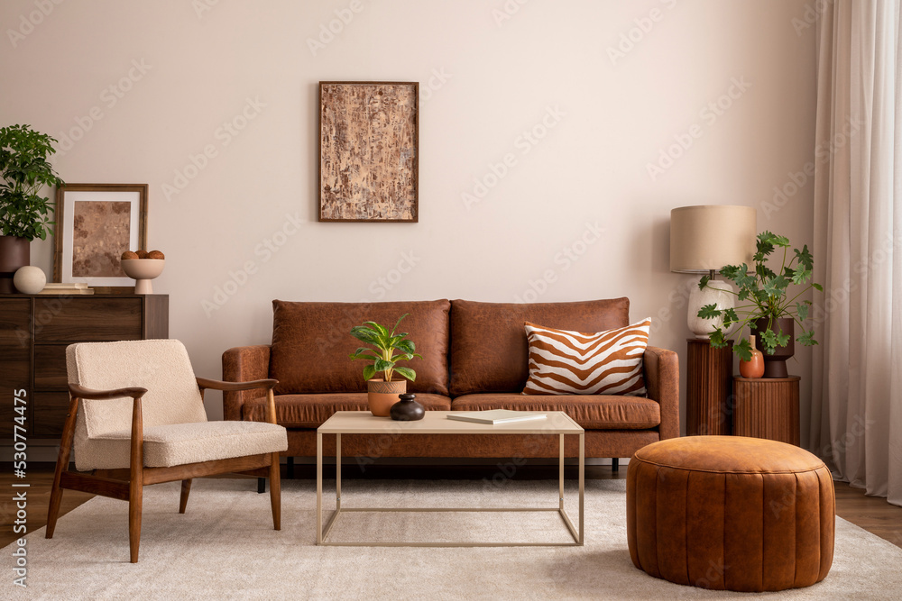 Leinwandbild Motiv - FollowTheFlow : Warm and cozy interior of living room space with brown sofa, pouf, beige carpet, lamp, mock up poster frame, decoration, plant and coffee table. Cozy home decor. Template. 