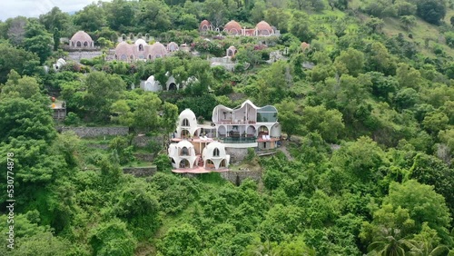 white dome villa hotel on mountain hill in Mentigi Bay Lombok Indonesia, aerial photo