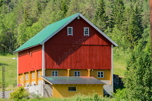 Beautiful red and yellow farm house in Norway at Valldalen valley.