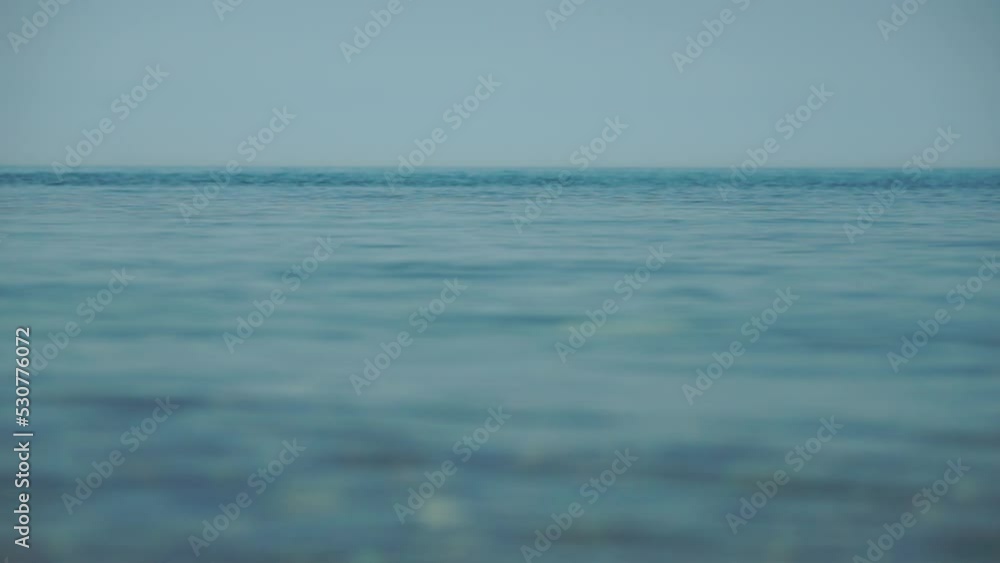 Abstract calm sea summer ocean sunset nature background. Small waves on water surface in motion blur with golden bokeh lights from sun. Holiday, vacation and recreational concept. Slow motion Abstract calm sea summer ocean sunset nature background. Small waves on water surface in motion blur with golden bokeh lights from sun. Holiday, vacation and recreational concept. Slow motion