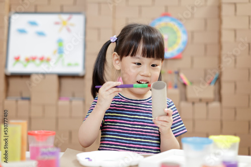 young girl making craft for homeschooling