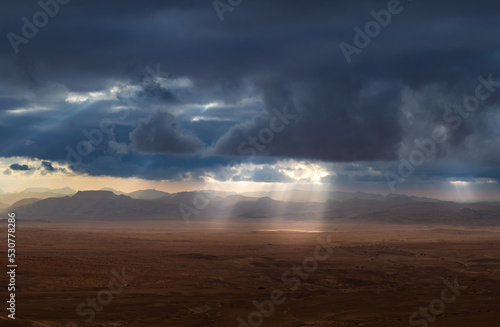 Storm clouds with sun rays in the Wadi Rum desert valley in Jordan