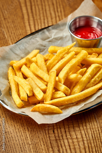 An appetizer - French fries with sauce. Close-up, selective focus