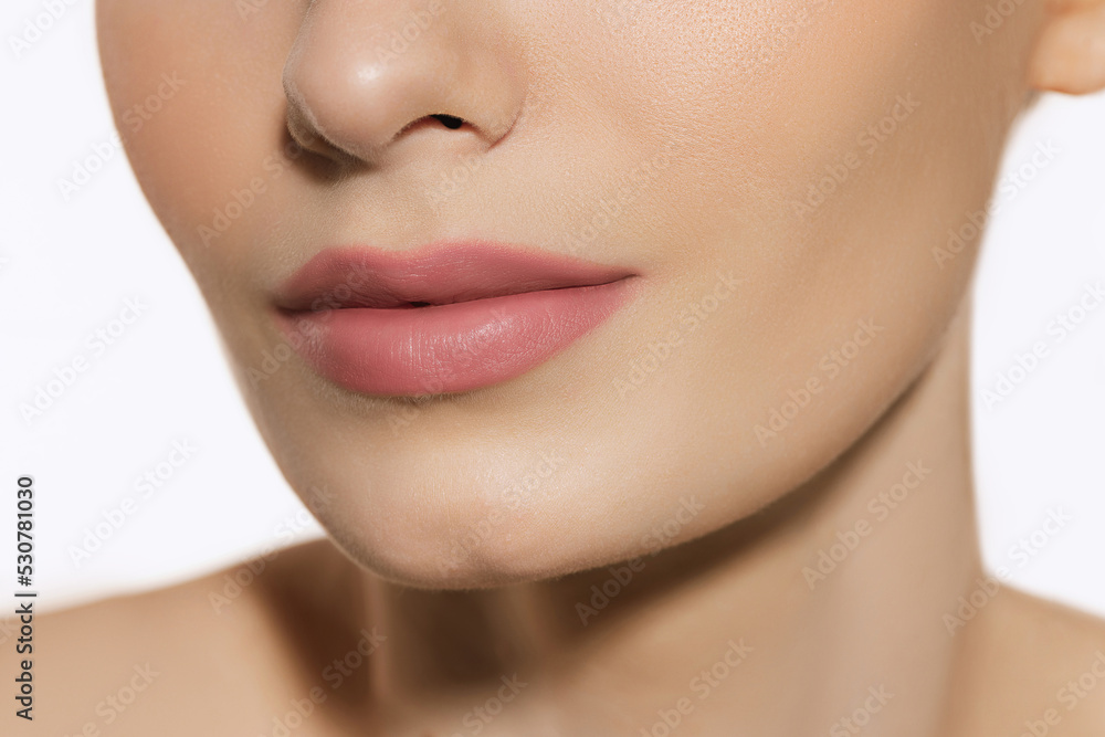 Closeup female lips, cheeks and nose isolated over white studio background. Concept of cosmetology, skincare, cosmetics, plastic surgery, ad Closeup female lips, cheeks and nose isolated over white studio background. Concept of cosmetology, skincare, cosmetics, plastic surgery, ad