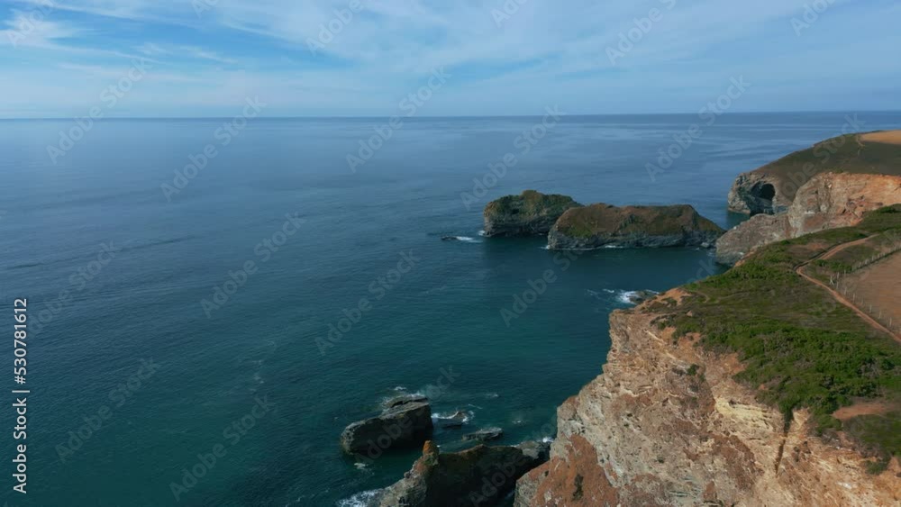 Cornwall seaside coast cliff at panoramic St. Ives and Hell's Mouth in summer with clear blue water waves. United Kingdom, England, UK near Newquay, epic cinematic drone aerial evening view. Cornwall seaside coast cliff at panoramic St. Ives and Hell's Mouth in summer with clear blue water waves. United Kingdom, England, UK near Newquay, epic cinematic drone aerial evening view.