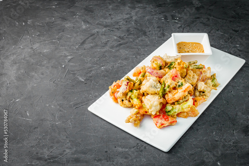 deep fried tempura vegetables on a dark background