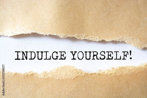 Valokuva indulge yourself message written under torn paper.