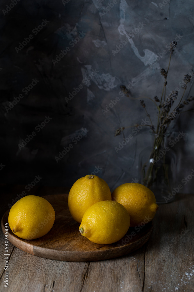 Lemons in a wooden cup on a rustic table