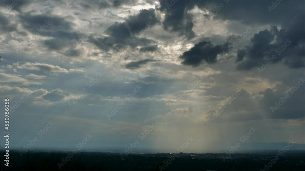 Time-lapse of Beautiful sunset scenery with Sun rays filtering through the clouds, casting a warm and enchanting glow on the hills of the valley. Time-lapse of Beautiful sunset scenery with Sun rays filtering through the clouds, casting a warm and enchanting glow on the hills of the valley.