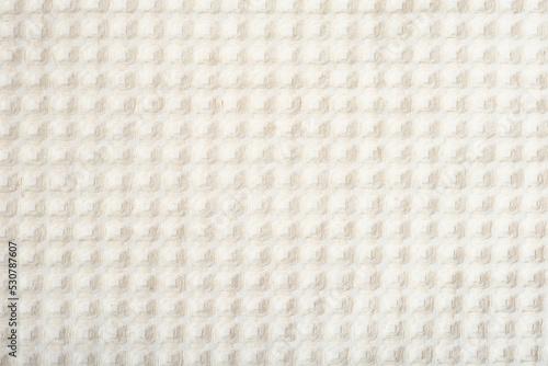 close up view of textured cotton fabric. unbleached linen textile, square pattern.