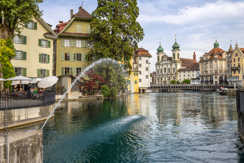 LUCERNE, SWITZERLAND, JUNE 21, 2022 - View of the Jesuit church of St. Franz Xaver on the Reuss river in Lucerne, Switzerland © faber121