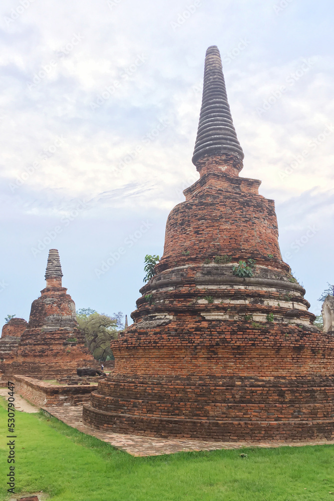 The ancient pagoda under the blue sky in the ancient city heritage historical at Ayutthaya, Thailand. The ancient pagoda under the blue sky in the ancient city heritage historical at Ayutthaya, Thailand.