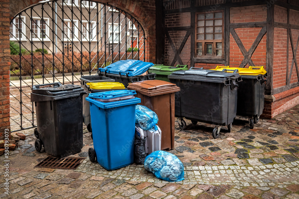 Garbage cans in different colors symbolizing recycling on the street Garbage cans in different colors symbolizing recycling on the street