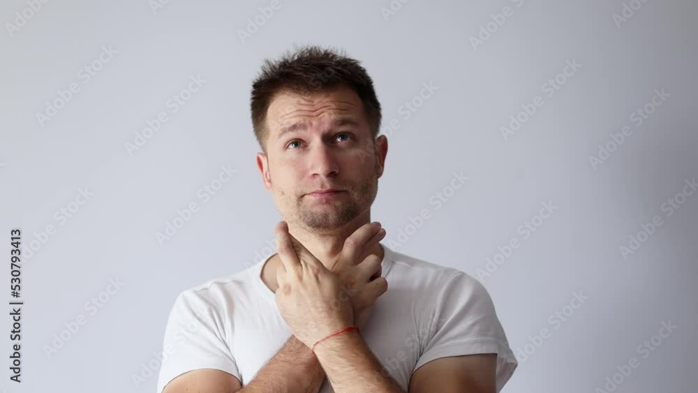 Handsome man in white t-shirt crossed his fingers and hopes Handsome man in white t-shirt crossed his fingers and hopes