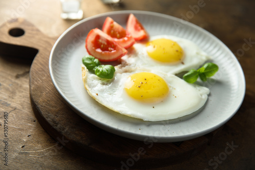 Roasted eggs with tomatoes and basil
