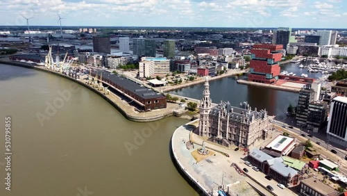 Beautiful aerial view of Antwerp Belgium covering the largest museum aan de stroom and the Loodswezen in a smooth cinematic footage. Dynamic urbanscape with lots of colors and touristy sites. photo