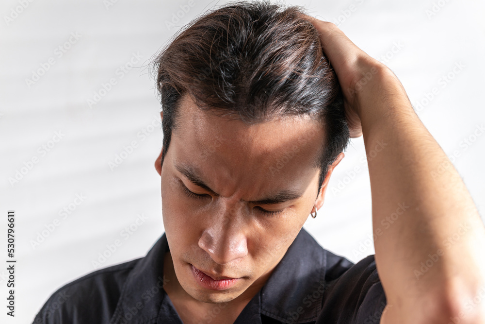 stress asian man nervous headache alone. loneliness frustration male person suffering from isolated tired pressure indoors. lonely attractive mental people depressed pain sad grief with difficulty