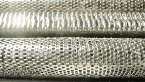 Mesh and blades from an electric shaver. Dolly slider extreme close-up. photo