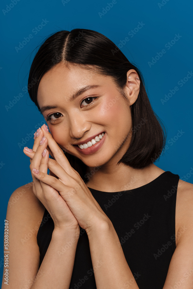 Portrait of young beautiful smiling asian woman with folded hands Portrait of young beautiful smiling asian woman with folded hands