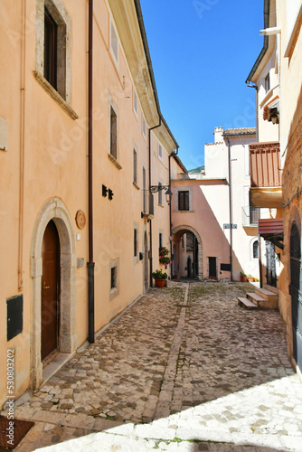 Fototapeta Naklejka Na Ścianę i Meble -  A narrow street between the old stone houses of Barrea, a medieval village in the Abruzzo region of Italy.