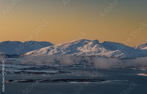 Sunset over the Norwegian fjord, winter photos at the golden hour, Tromso, Norway