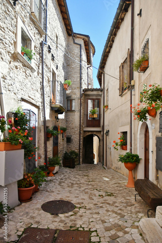 A narrow street between the old stone houses of Barrea, a medieval village in the Abruzzo region of Italy. photo