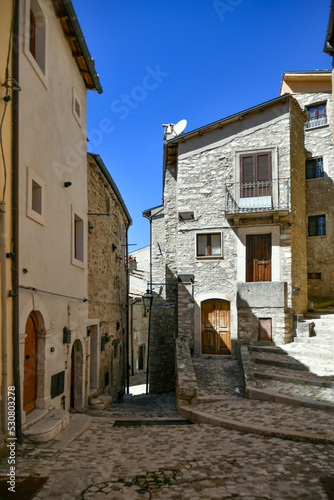 A narrow street between the old stone houses of Barrea, a medieval village in the Abruzzo region of Italy. © Giambattista