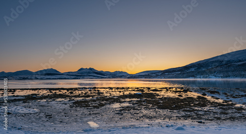 Sunset over the Norwegian fjord, winter photos at the golden hour, Tromso, Norway