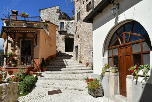 A narrow street between the old stone houses of Barrea, a medieval village in the Abruzzo region of Italy.