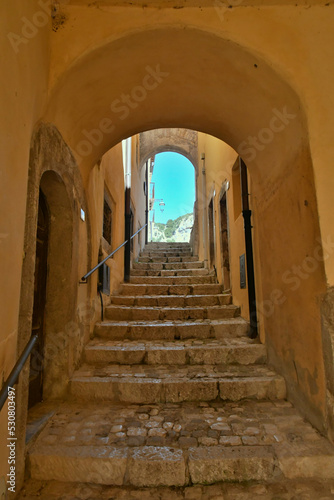 A narrow street between the old stone houses of Barrea  a medieval village in the Abruzzo region of Italy.