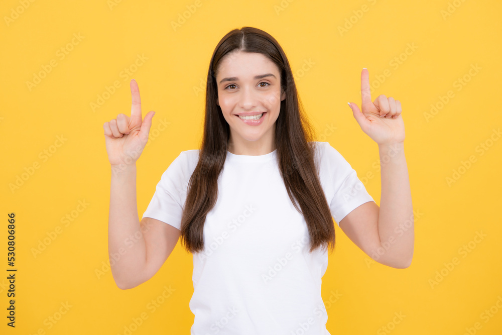 Woman point at copy space, showing copyspace pointing up. Promo, girl showing advertisement content gesture, pointing with hand recommend product. Isolated background. Woman point at copy space, showing copyspace pointing up. Promo, girl showing advertisement content gesture, pointing with hand recommend product. Isolated background.