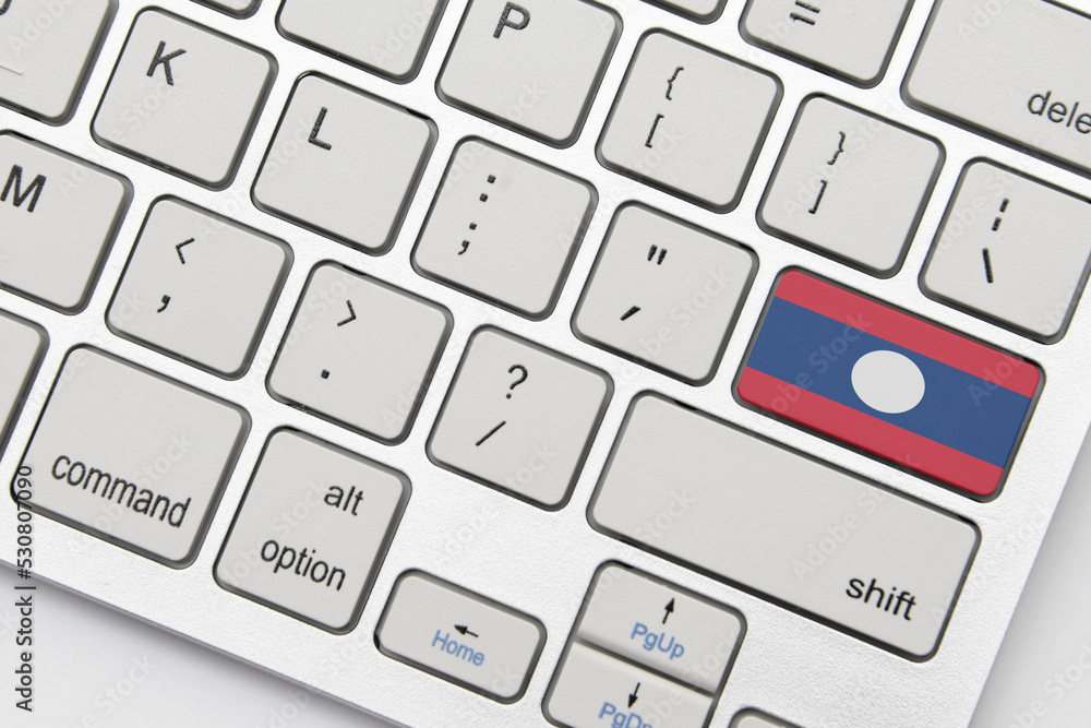 national flag of laos on the keyboard on a grey background .3d illustration national flag of laos on the keyboard on a grey background .3d illustration