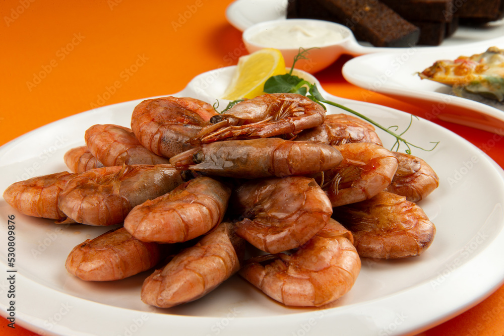 Fried shrimp in a plate on a yellow background. Fried shrimp in a plate on a yellow background.