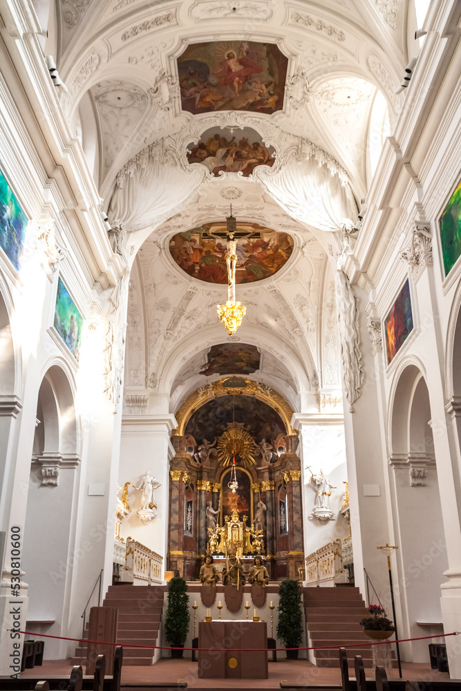 Great view of the choir and the altar apse that are elevated above the east crypt inside the famous Neumünster Collegiate church in Würzburg, Germany. Above hangs the late Gothic Romanesque crucifix. 