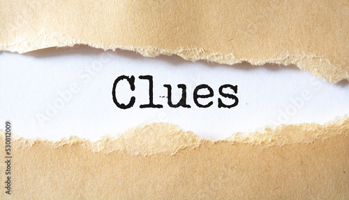 Clues on brown torn paper